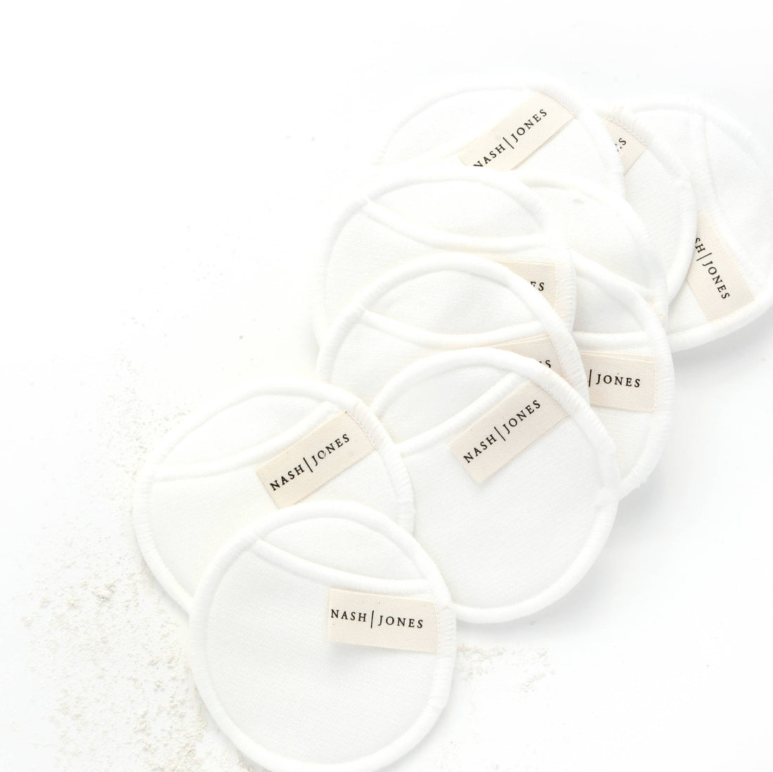 Nash and Jones Bamboo and Cotton Reusable Facial Pads, white, arranged diagonally in a flat lay on a white surface.