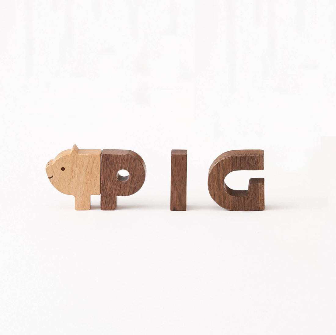 Wooden Alphabet Play Blocks: light beech wood pig head block connecting to dark walnut wood letters spelling PIG, front view…