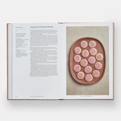 
                    
                      Crumbs: Cookies And Sweets From Around The World cookbook, open to 'Hundreds and Thousands Biscuits' recipe and pink-iced…
                    
                  