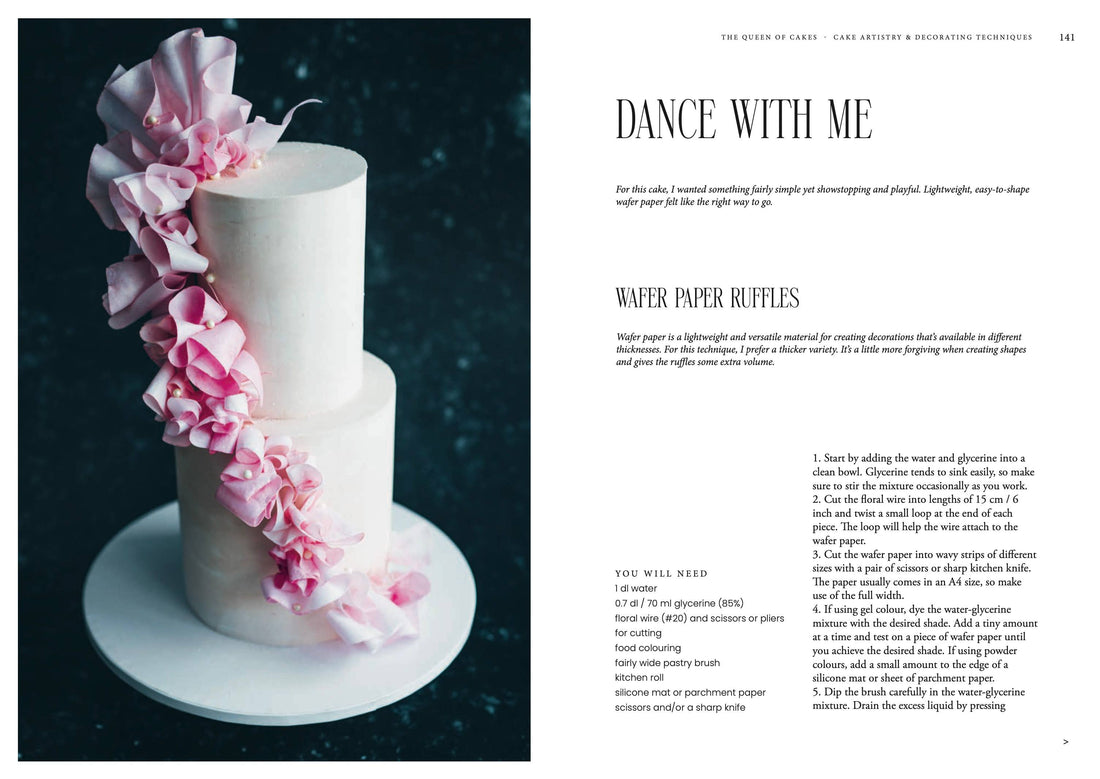 Queen of the Cakes Gluten-free baking book, open page with 'Wafer Paper Ruffles' recipe, showing two-tier white cake with…