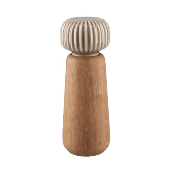 Danish Design Collective Hammershøi spice grinder, oiled oak base with ribbed porcelain top, front on white.