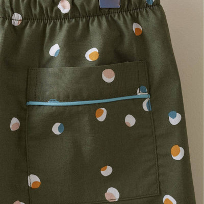 
                    
                      Kids Confetti Pajamas, olive green cotton with white, peach, blue, orange confetti print. Close-up of pocket with blue…
                    
                  