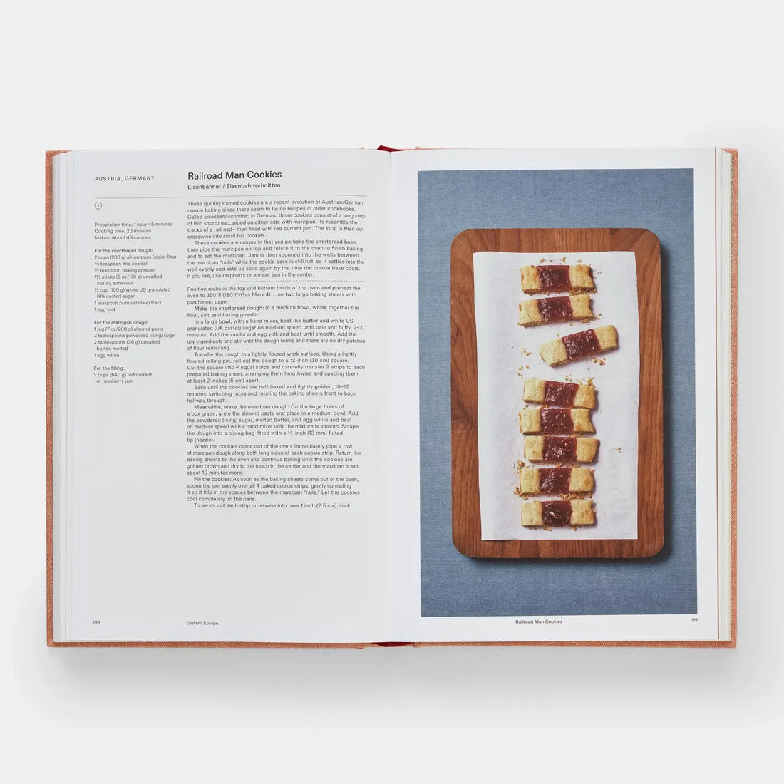 Crumbs: Cookies And Sweets From Around the World cookbook, open to a recipe page showing jam-filled Railroad Man Cookies on…