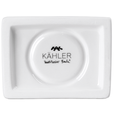 
                    
                      Urbania Church ceramic candle holder, white Dolomite, bottom view highlighting KÄHLER brand stamp and designer's signature.
                    
                  