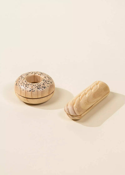 
                    
                      Wooden Bakery Set toys: bagel with black & white sesame seeds & carved baguette, displayed side by side.
                    
                  