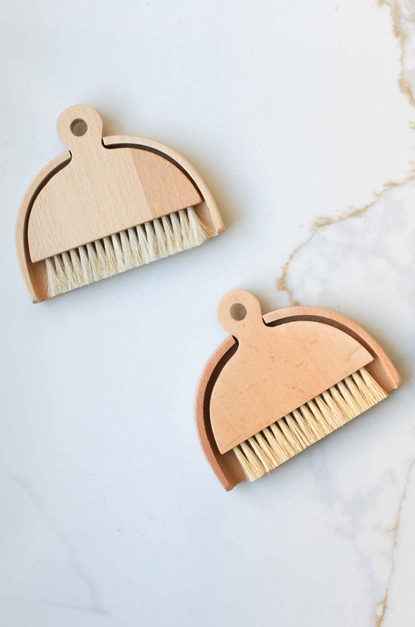 Fodory Table Brush, pair of light wood and sisal bristle table brushes with dustpans, flat lay on white marble.