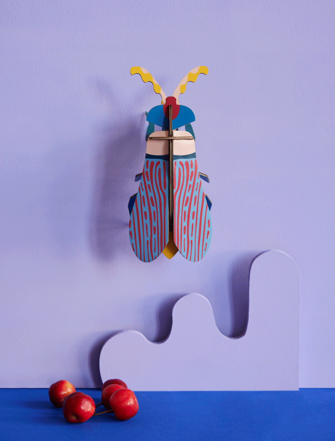 3D Striped Wing Beetle model kit, vibrant blue and red striped wings, yellow antennae, recycled cardboard, hanging on a…
