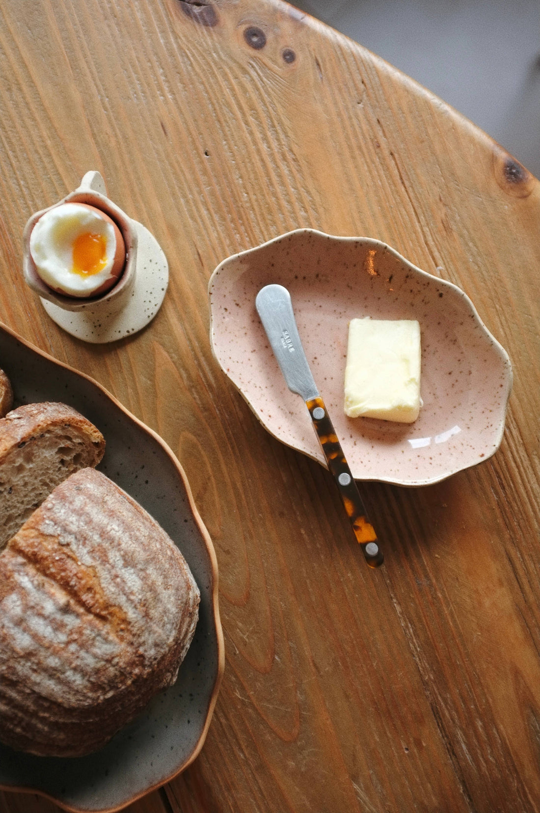 Handcrafted Stoneware Tray, speckled light pink stoneware, overhead view showing its use for butter and a knife.