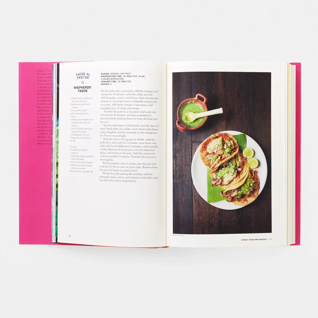 Mexico: The Cookbook open to a vibrant full-page photo of three Tacos Al Pastor with green salsa and limes.