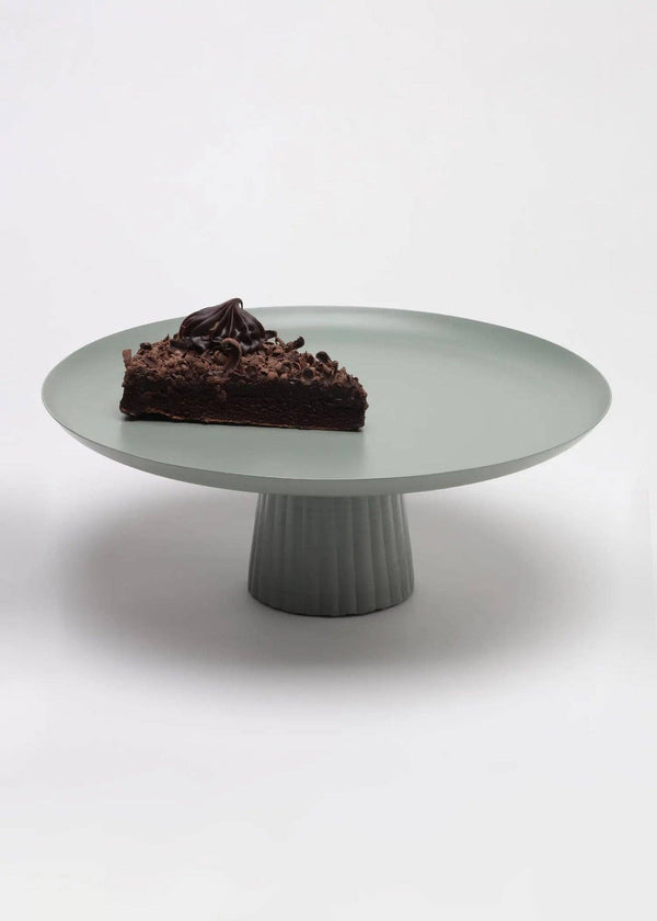 Casa Amarosa Avisa cake stand, sage green powder-coated metal with fluted base, front view on white with cake.