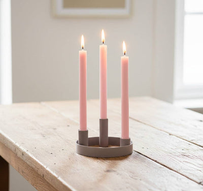 
                    
                      British Colour Standard Round Metal Candelabra Ring, grey painted steel, holding three lit Old Rose pink taper candles, on…
                    
                  