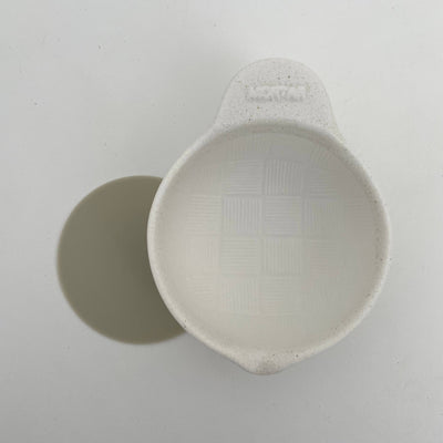 
                    
                      Japanese Ceramic Mortar, white porcelain bowl, ridged grinding interior, with a round gray non-slip pad, top-down view.
                    
                  