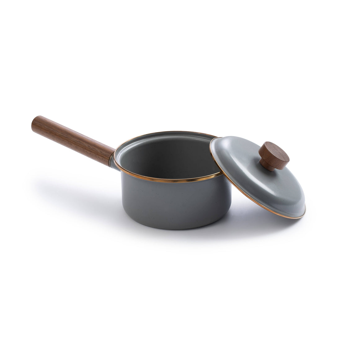 Gray enamel saucepan, walnut handle, with lid ajar showing interior and gold rim detail on white.