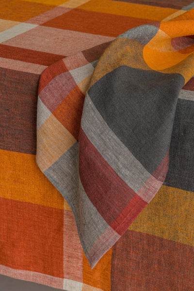
                    
                      Eugene Linen Napkin, Classic Checks pattern in orange, reddish-brown, dark grey linen, folded view with weave detail.
                    
                  