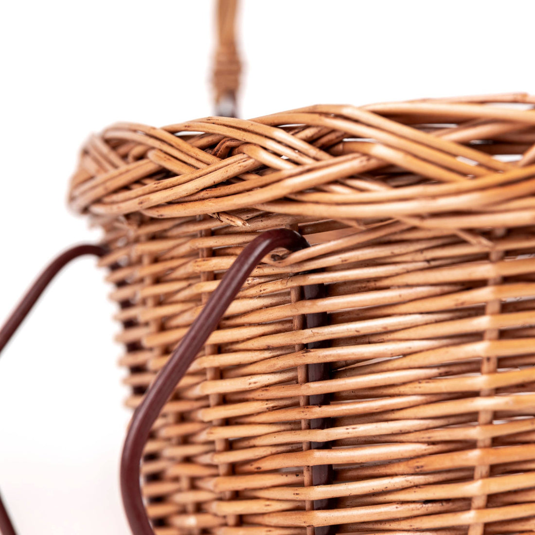 Natural rattan Wicker Bicycle Basket, close-up view of light brown weave and dark metal attachment loops.