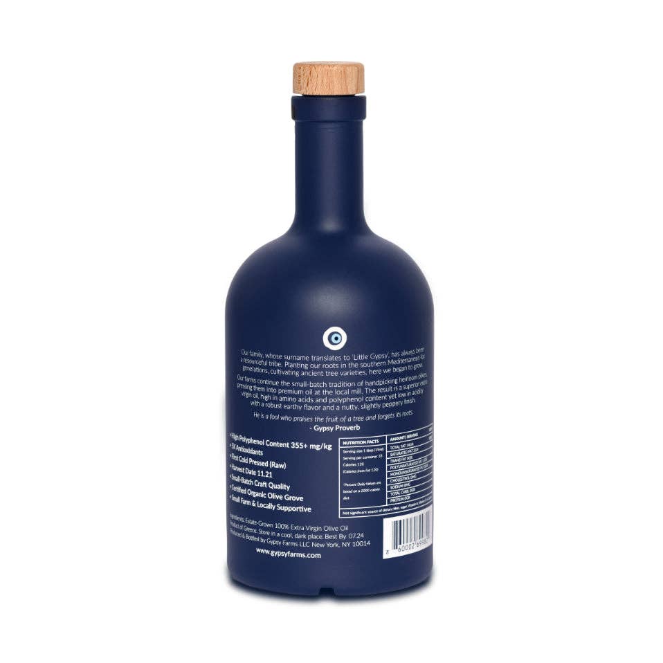 High Mountain Organic olive oil, navy blue bottle with wooden cork stopper, back label showing product details.