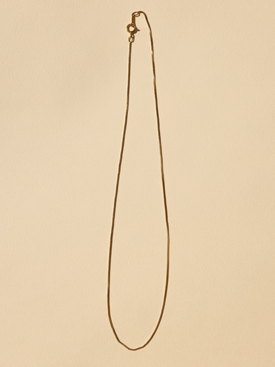 
                    
                      Delicate Box Chain Necklace, 18K gold-filled, full length flat lay view with lobster clasp detail.
                    
                  