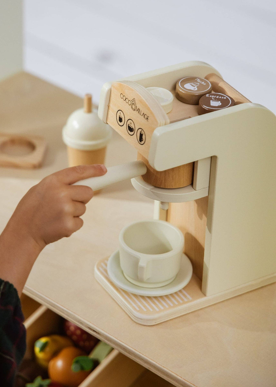 Wooden Coffee Maker Set, child's hand interacting with cream lever, natural wood accents, with 'Mocha' and 'Espresso' pods.