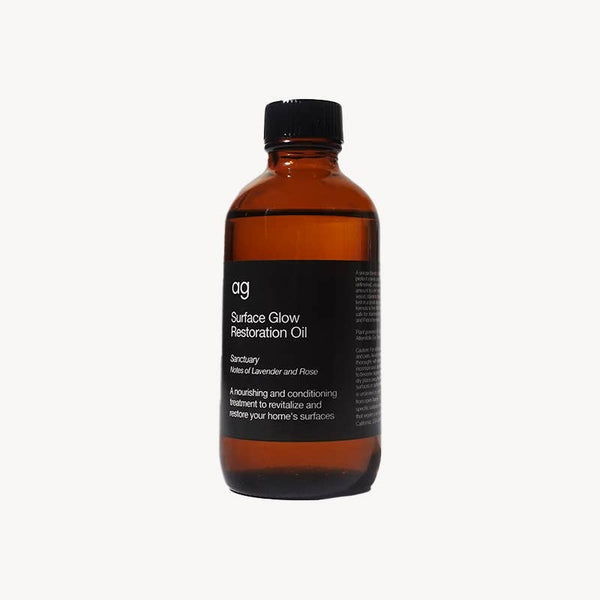 Ardent Goods Surface Glow Restoration Oil, amber glass bottle with black label, full front view on white.