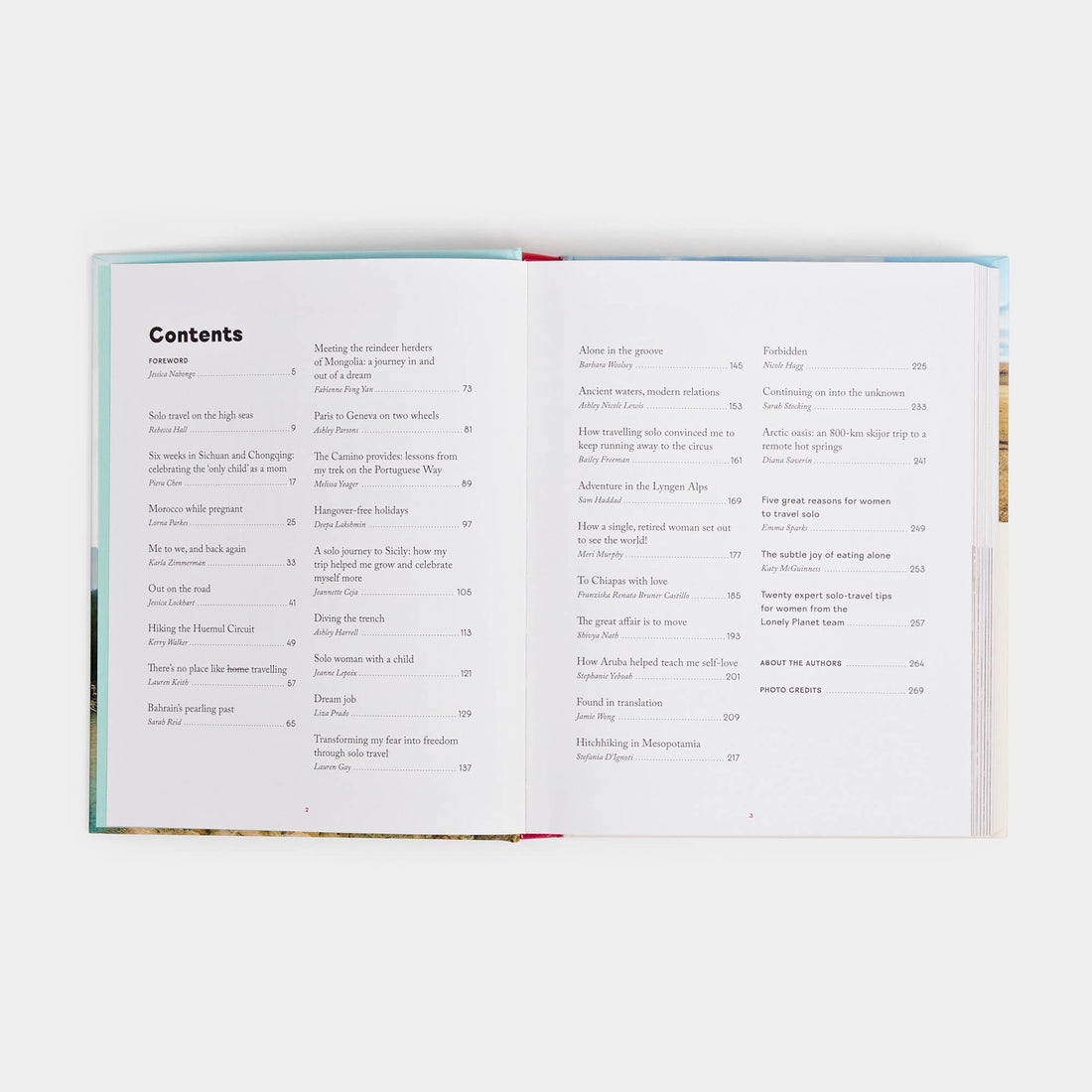 Women Travel Solo paperback book, open flat to detailed table of contents, white pages with story titles and authors.
