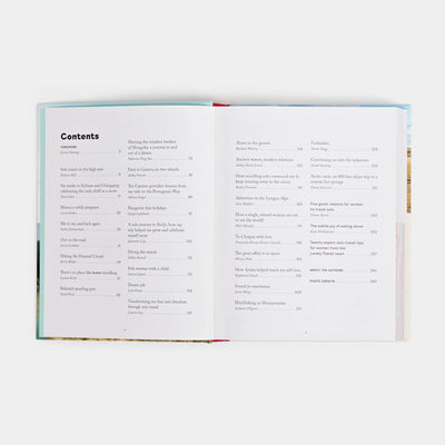 
                    
                      Women Travel Solo paperback book, open flat to detailed table of contents, white pages with story titles and authors.
                    
                  
