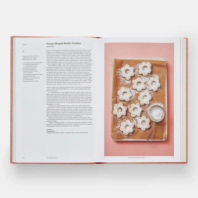 
                    
                      Crumbs: Cookies And Sweets From Around the World cookbook, open to recipe page for Flower-Shaped Butter Cookies. Opposite, a…
                    
                  