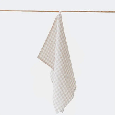 
                    
                      Premium Linen Tea Towel, natural and white checked pattern, 100% linen, hanging by its loop on a wooden rod.
                    
                  