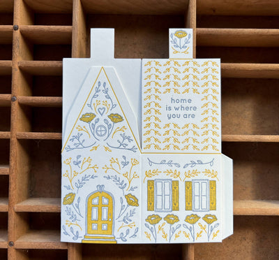 
                    
                      Home Is Where You Are 3D die-cut greeting card, unfolded, featuring yellow & grey letterpress house illustration with door,…
                    
                  
