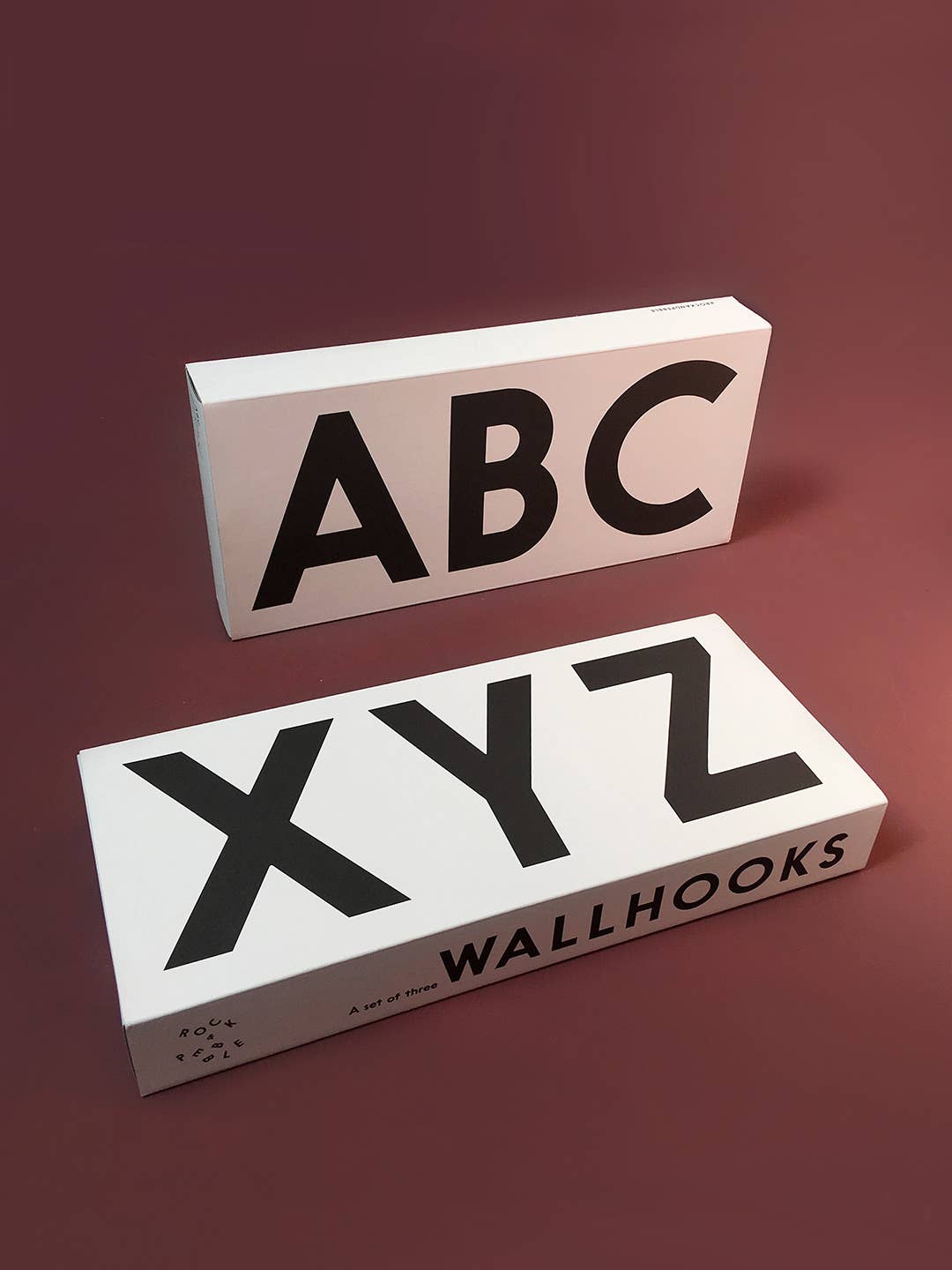 Alphabet Wall Hooks, two white packaged sets with bold black 'ABC' and 'XYZ' letters, angled display.