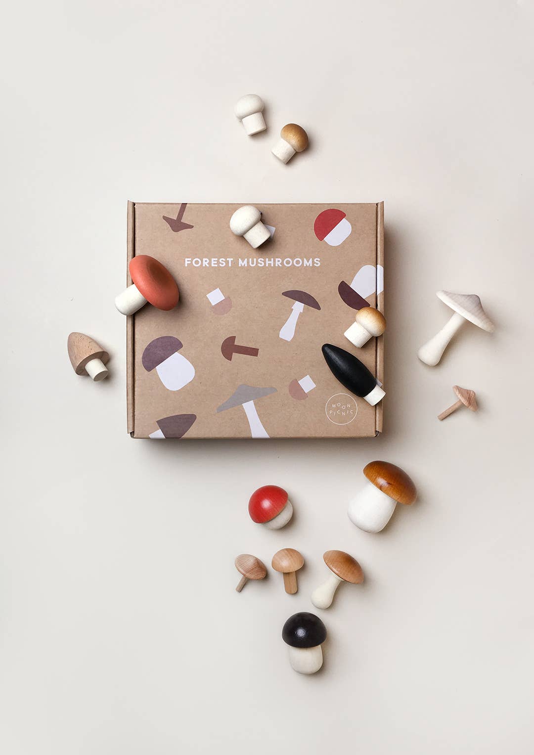 Forest Mushrooms In A Box wooden pretend play food set, solid beech wood mushrooms in varied colors, scattered around kraft…