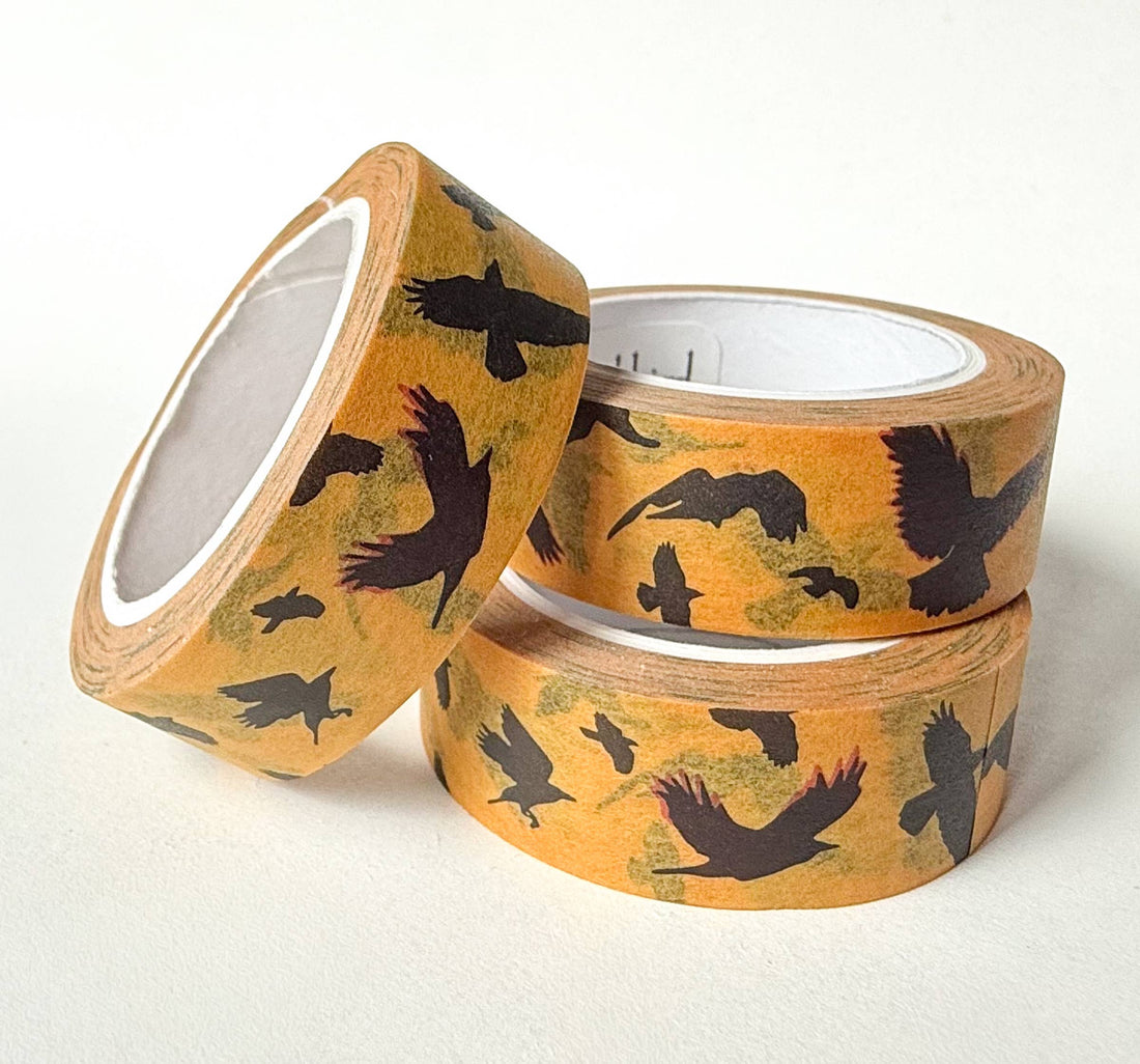 Flying Crows washi tape, three rolls stacked. Yellow pattern with black bird silhouettes, highlighting rice paper texture.
