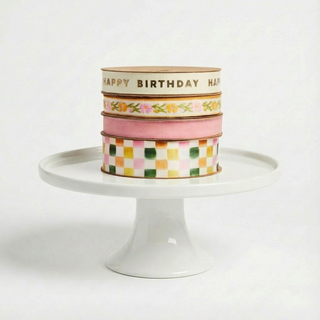 Abigail Jayne Design Happy Birthday and Celebration Ribbons, 4 spools stacked, gold text, floral, pink, checkered patterns.