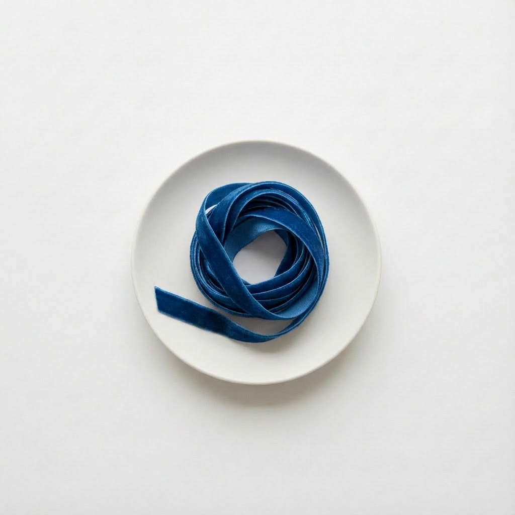 Blue ribbon on a white plate with a white background