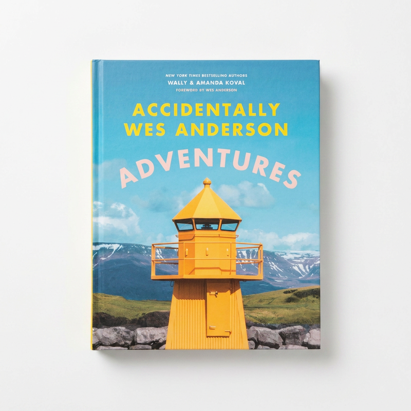 Hachette Book Group Accidentally Wes Anderson: Adventures hardcover book, colorful cover art with yellow lighthouse, blue…