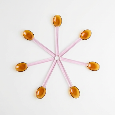 
                    
                      Pink and Amber Borosilicate Stirring Spoons, eight arranged in a star shape, flat lay.
                    
                  