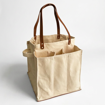 
                    
                      Natural cotton canvas Multi-Pocket Market Tote with brown vegan leather straps & base, angled view showing multiple exterior…
                    
                  