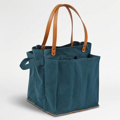 
                    
                      Multi-Pocket Canvas Market Tote, teal canvas with tan vegan leather straps and base, angled view showing multiple exterior…
                    
                  