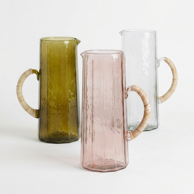 
                    
                      Casa Amarosa Handblown Hammered Glass Pitchers, set of three: olive green, rose pink, and clear glass with rattan handles,…
                    
                  