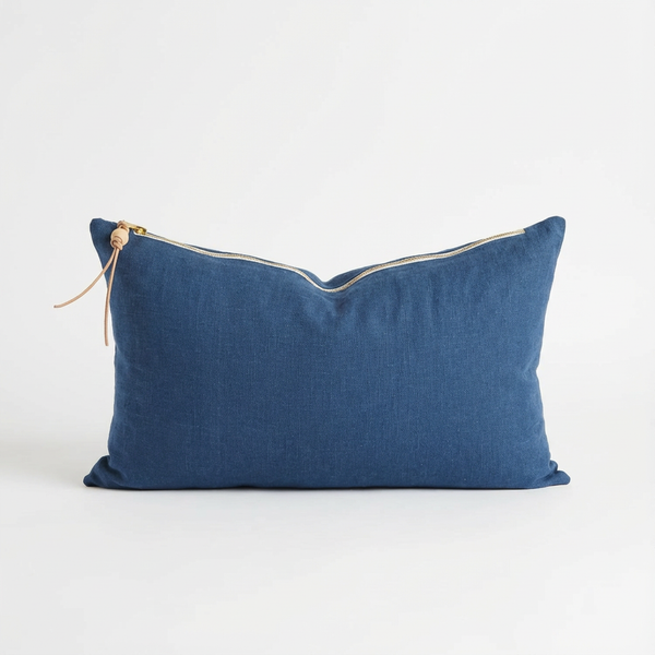 Celina Mancurti Washed Linen throw pillow, blue, with natural leather pull, wood bead, and brass zipper, front view.
