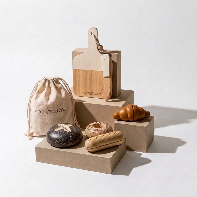 Coco Village Wooden Bakery Set play toys: natural wood cutting board, knife, bread, croissant, bagel, and dark loaf