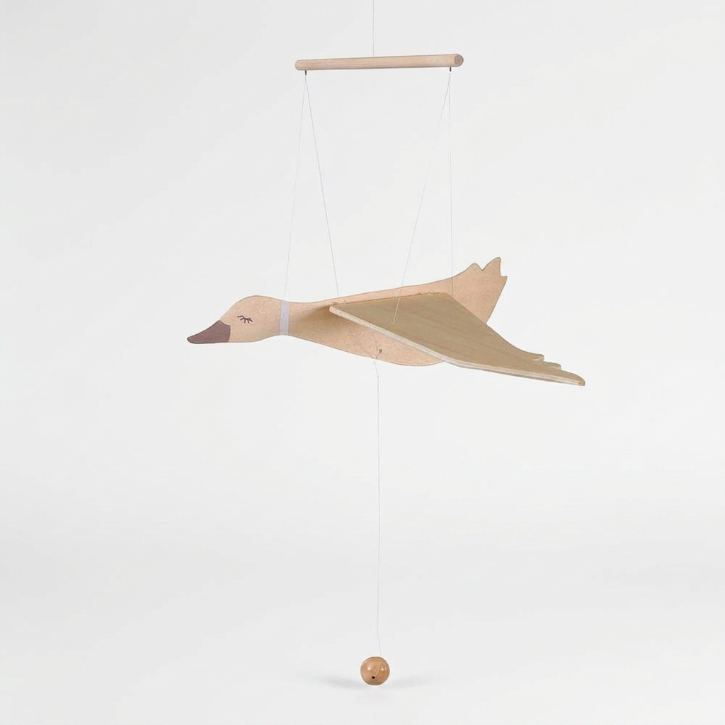Wooden Flying Goose mobile, natural wood with painted olive green wings, dark brown beak, side view showing pull cord and…