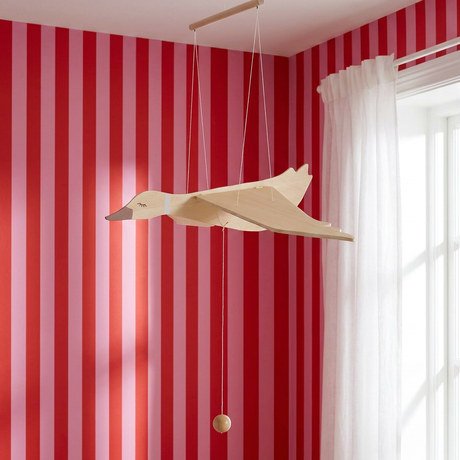 Wooden Flying Goose Mobile, natural wood with light brown painted details, hanging angled in a room, showing wings, full…