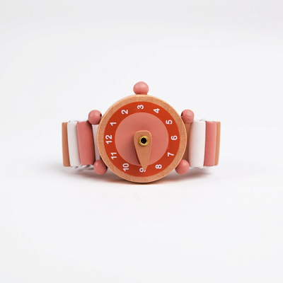 
                    
                      Emma wooden toy watch, natural wood face, pink dial, white and pink segmented elastic band detail, front view.
                    
                  