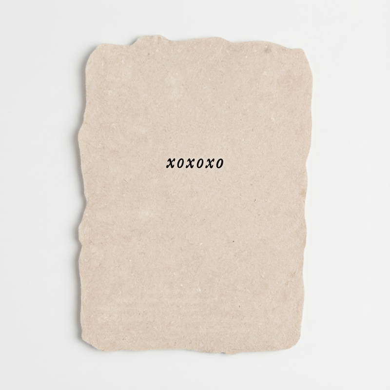 Farmette 'XOXO' Flat Note Card, light beige handmade paper with deckled edges and black letterpress text, front view on…