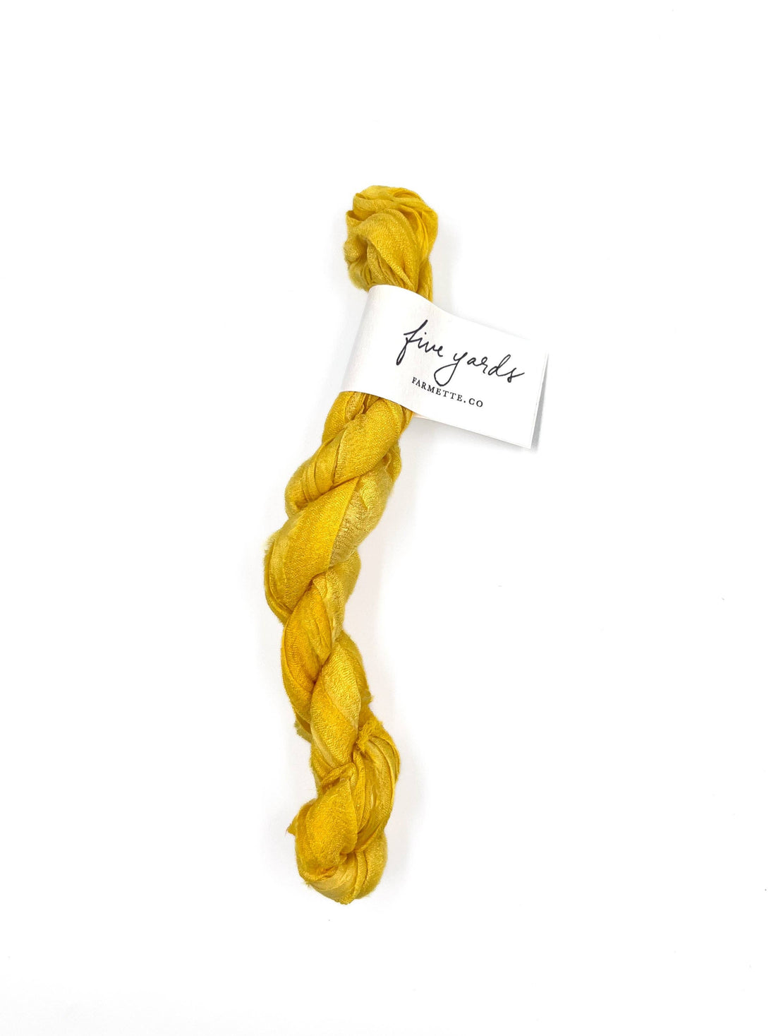 Sari Silk Ribbon - Sunflower, plant-dyed recycled silk, twisted bundle with Farmette 'five yards' tag, on white.