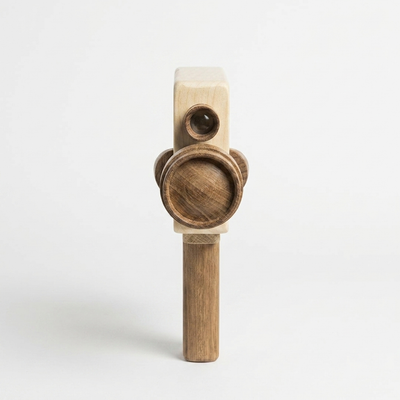 
                    
                      Pretend Film Camera wooden toy camera, light rubber wood body with dark sapele teak wood lens and handle, upright front view.
                    
                  