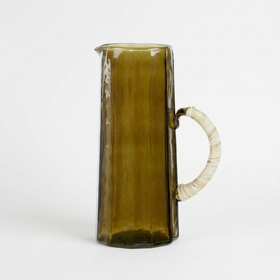 
                    
                      Hammered Glass Pitcher, dark olive handblown glass with textured fluting and natural wrapped handle, full side view.
                    
                  