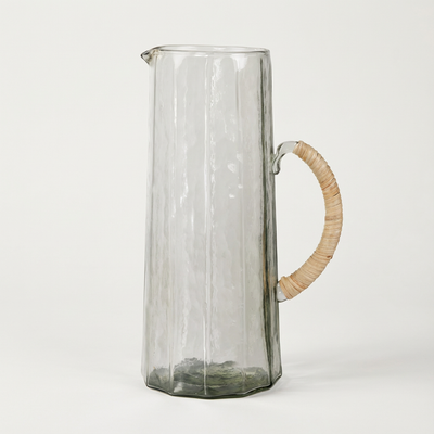 
                    
                      Handblown Hammered Glass Pitcher, clear handblown glass with vertical fluting, hammered texture, natural rattan handle,…
                    
                  