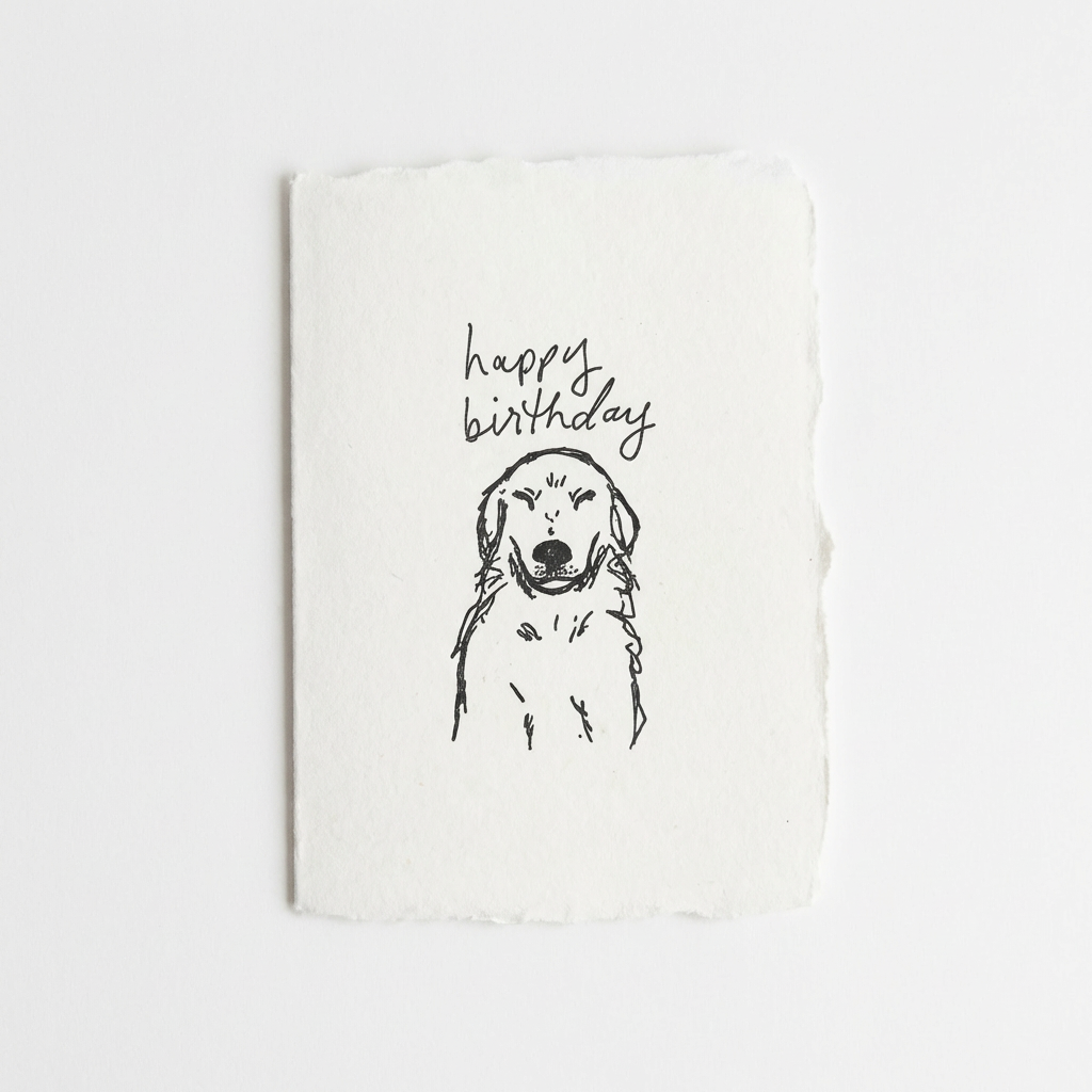 White letterpress card with a black line drawing of a golden retriever and 'happy birthday' text on a white background