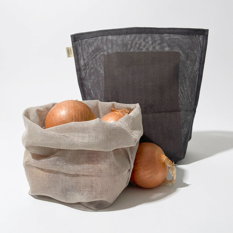 Ban Inoue Japanese Cotton Gauze Storage Bags: natural bag with onions, charcoal bag, front view on white.